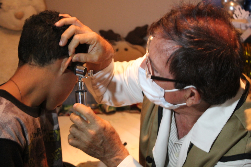 A doctor examines a boy’s ear during a medical visit in Venezuela.