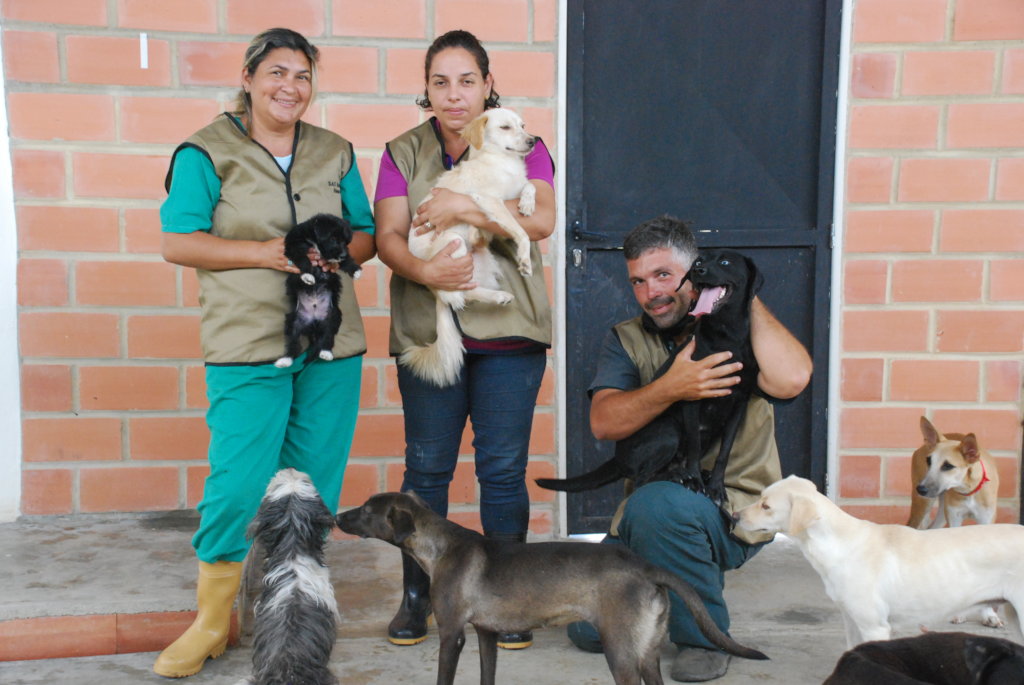 SAI team members standing with rescued dogs at a shelter in Venezuela.