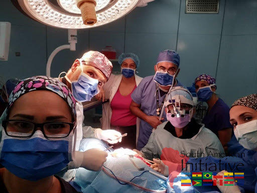 The SAI neurosurgery team poses in the operating room during a life-saving surgical procedure.