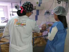 Medical staff stand beside a child patient after the first successfully completed surgery.