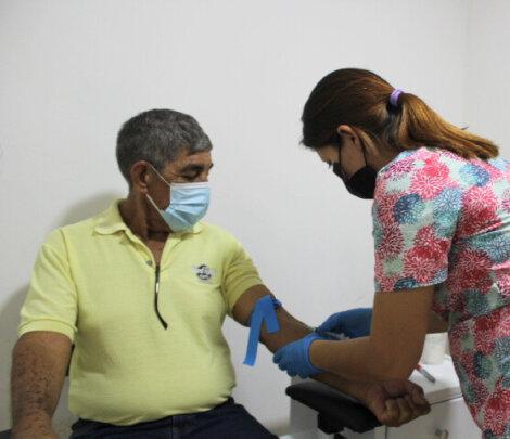 Elderly Patient Getting Blood Testing Done At SAI Clinic
