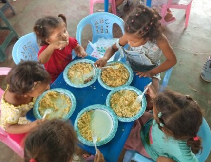 Orphans happily eating nutritious food